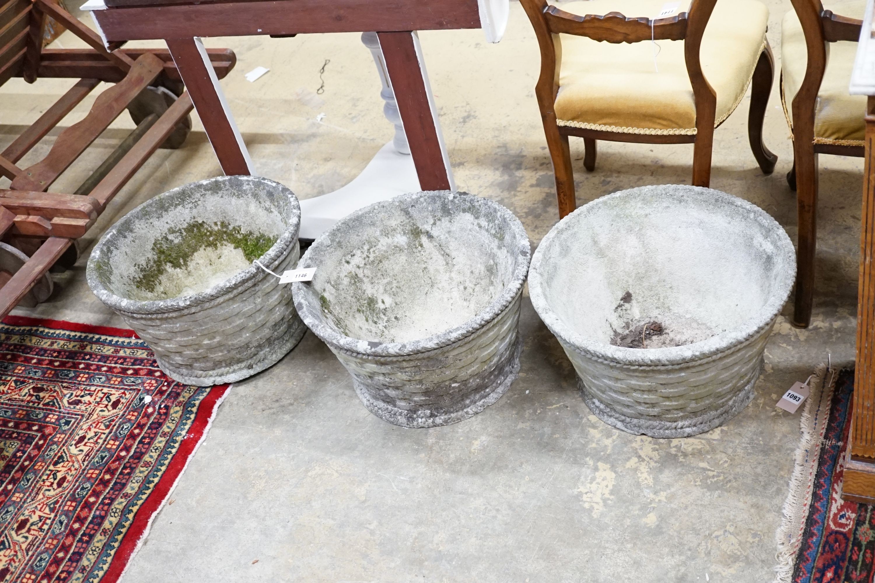 A set of three reconstituted stone basket weave circular garden planters, diameter 45cm, height 28cm